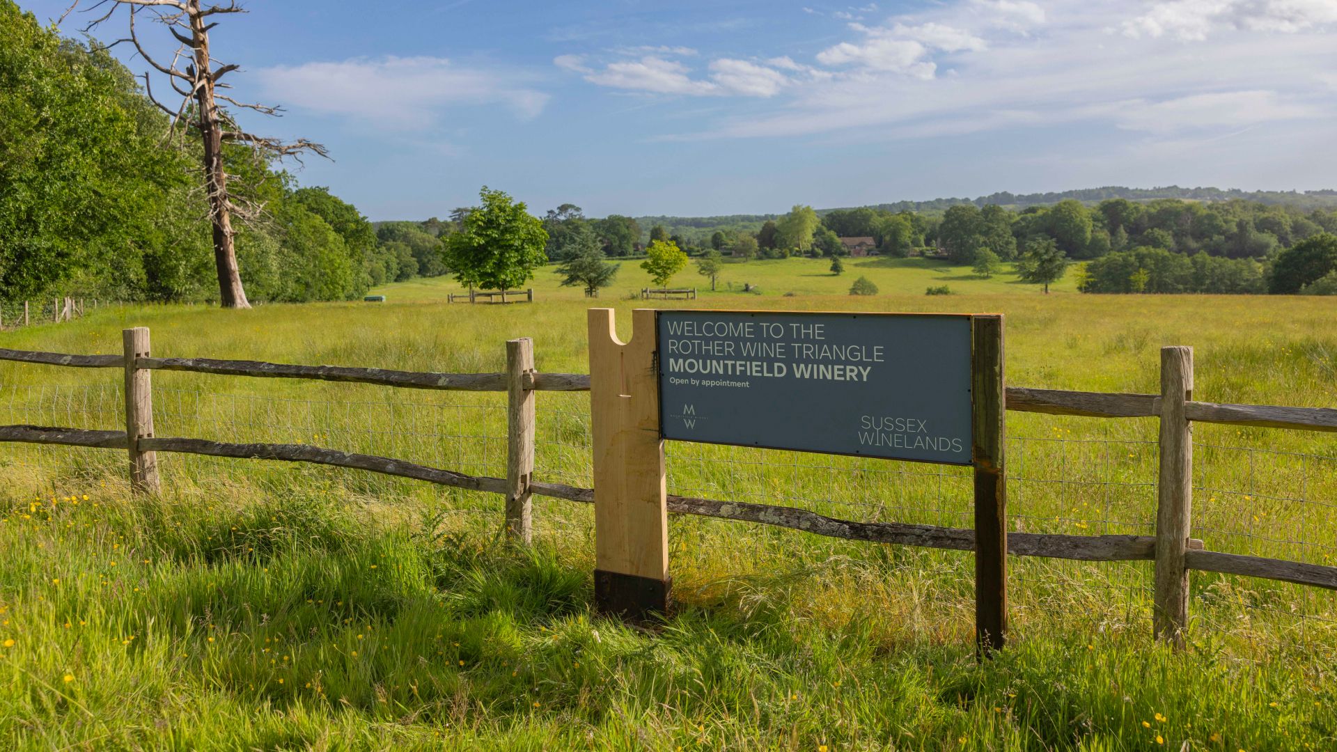 The Sussex Winelands signage in the foreground of the surrounding countryside at Mountfield Winery